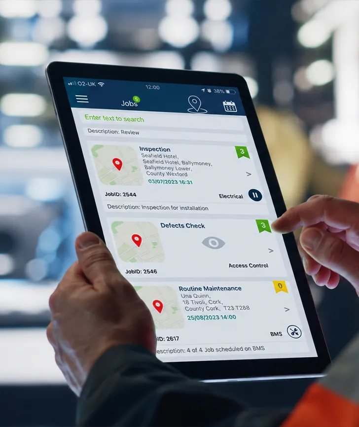 Engineer using the ServiceJobs app on a tablet on site